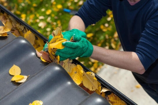 Residential Gutter Cleaning Services by APS Charlotte Residential gutter cleaning removing leaves and debris by hand for proper drainage